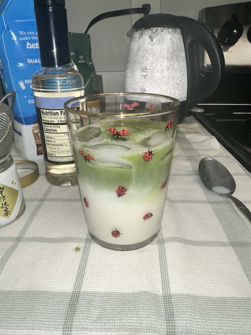 A matcha latte in a glass cup
